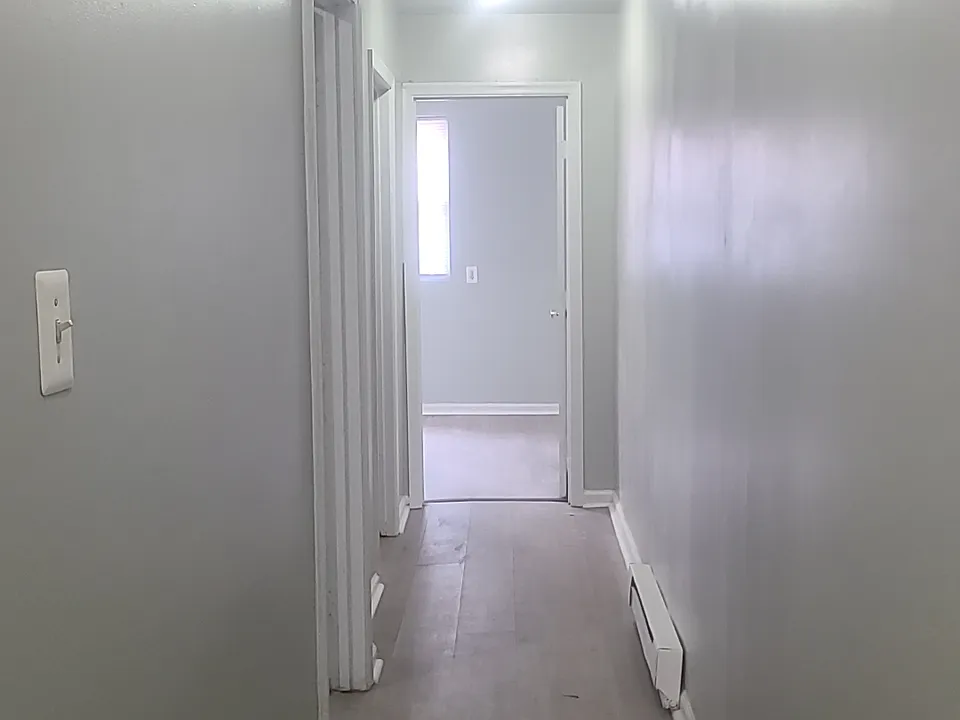 Long hallway leading to both bedrooms