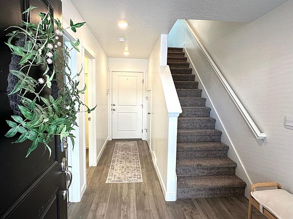 Entering the home - office/bedroom (and bath) on left, garage to back, stairs up to living area