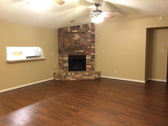 Large living area with dual fans and fireplace