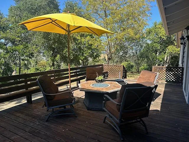 Large wooden deck off off the kitchen and family room