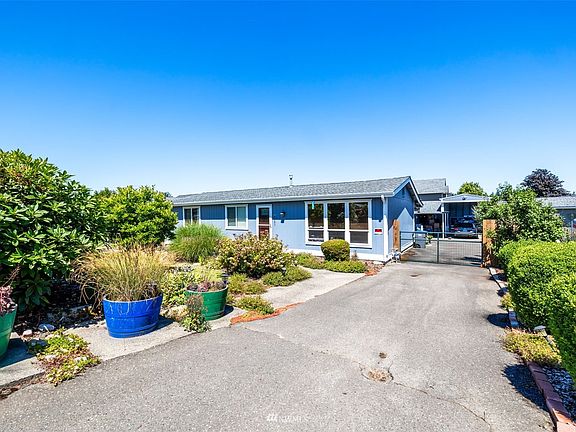 Paved and gated driveway leading back to the RV sized covered carport and shop. >