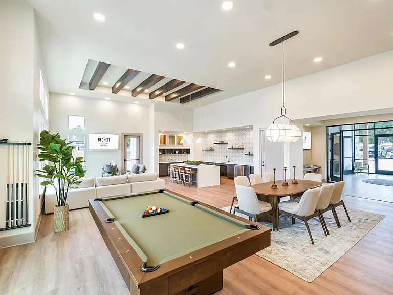Expansive clubroom with gathering space, lounge seating, and billiards.