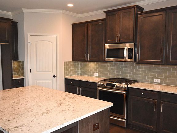 Stunning features throughout this home including under cabinet lighting & high-end granite!