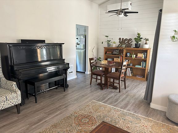 Piano in great room with shiplap accent wall.