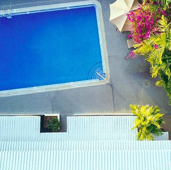 View of condo from up above. The pool deck and loungers righ
