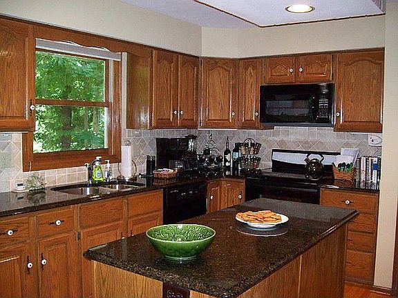 Updated kitchen with granite, tile, lighting, appliances