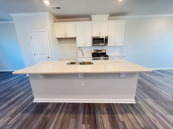 quartz countertops with a huge island. Refrigerator will be provided
