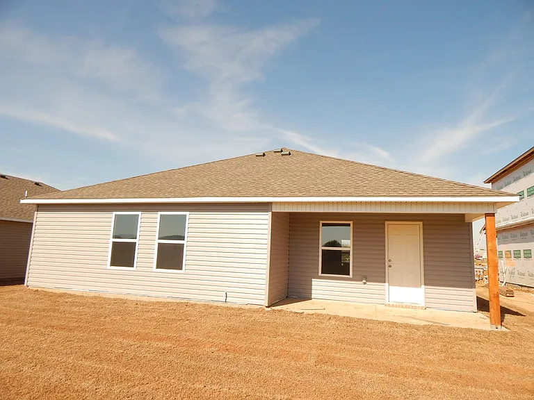 Covered back porch overlooks small privacy
 fenced backyard. No neighbors behind!