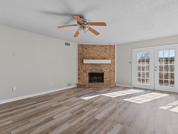 Snuggle up to a cozy fire while enjoying back yard views through the French doors.