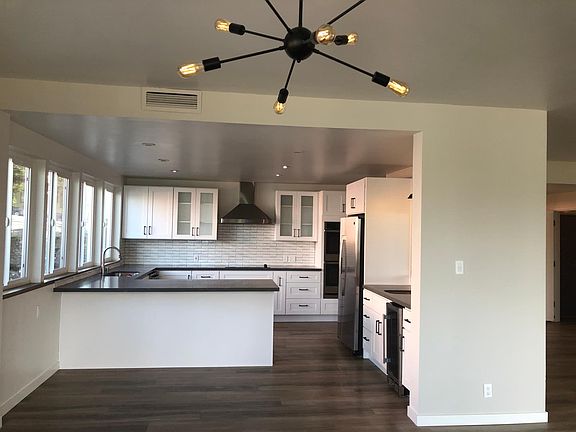 Large kitchen with counter seating/ flows to dining area