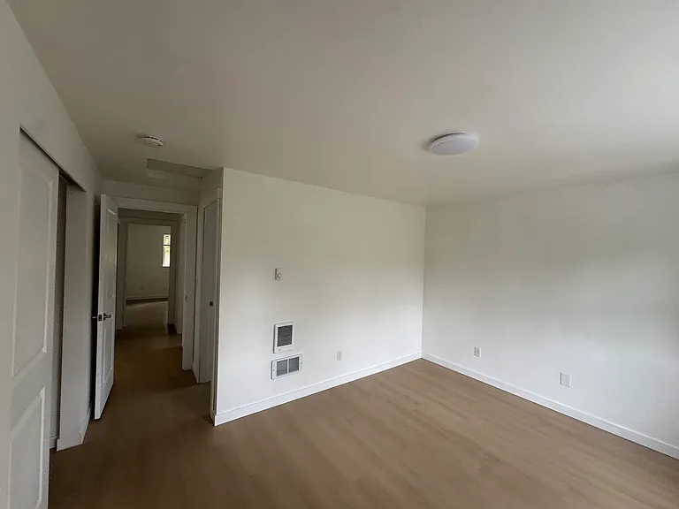 View from the primary bedroom toward the hallway, with easy access to the second bedroom and full bathroom.