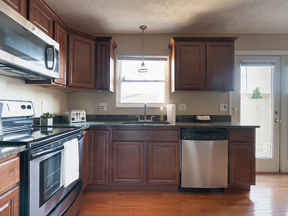 New stainless appliances, granite countertops, and cherry wood cabinetry.