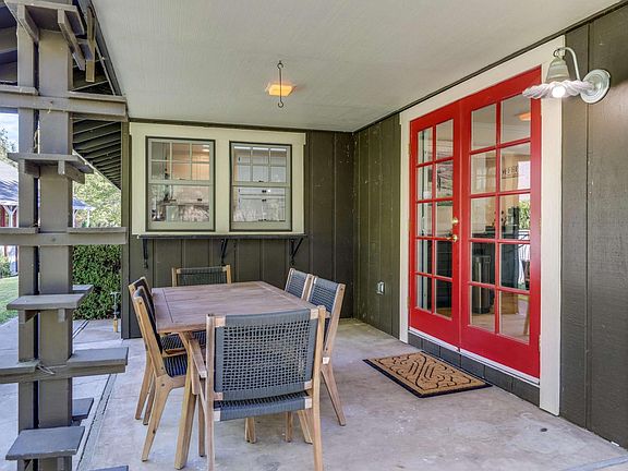 sitting area outside kitchen. red doors lead to dining area