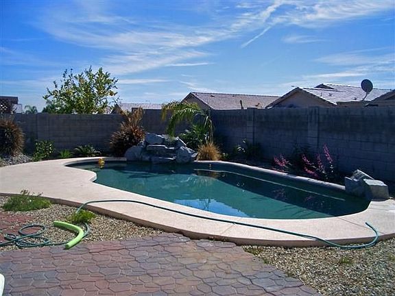 Pebble Tec pool with rock waterfall and deck. Relax!
