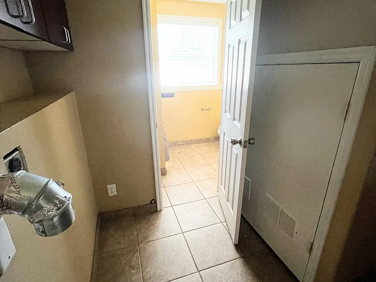 Laundry area leads into bathroom