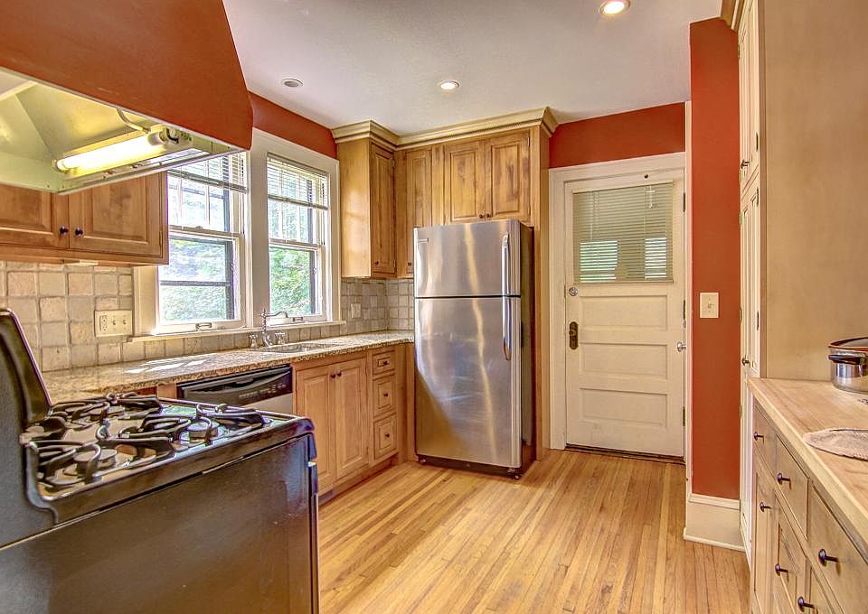 Lovely bright kitchen with LOADS of cabinetry. Mudroom is out that back door. Laundry and basement is out a door on the right.