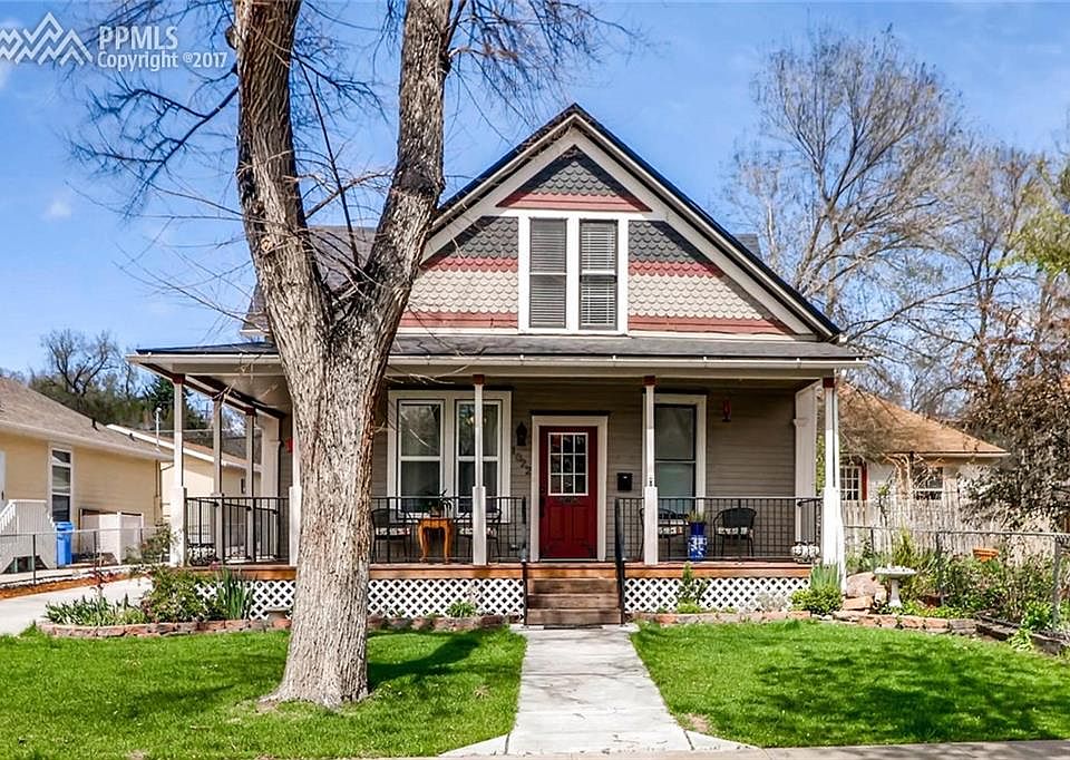 Wrap around porch, concrete drive to 2-car detached garage.