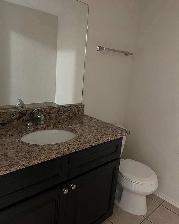 Bathroom with vanity and light tile patterned flooring