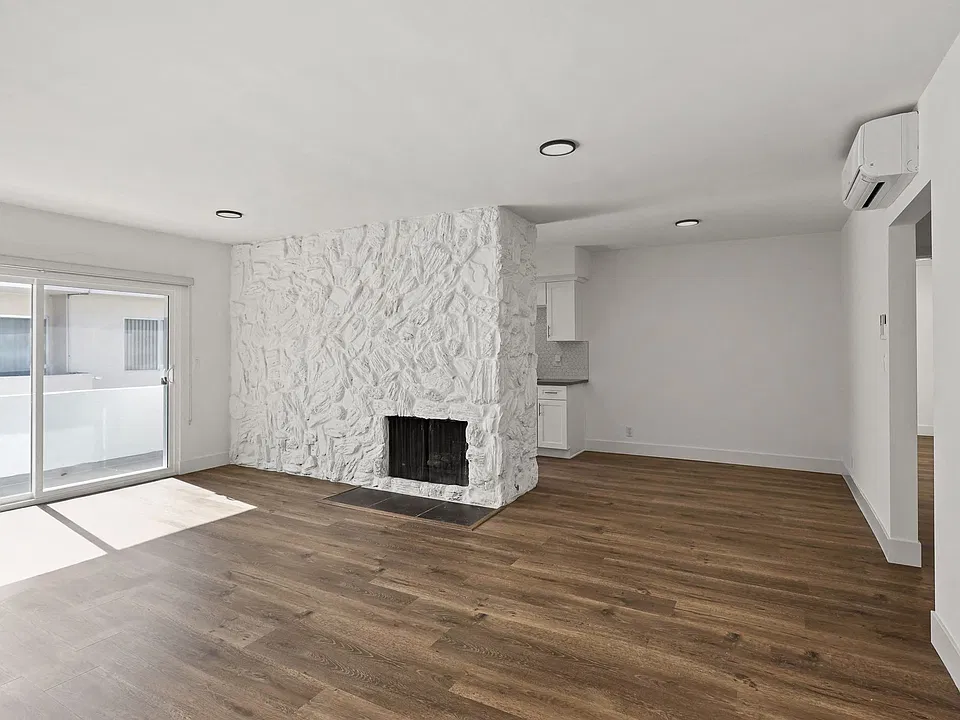 Living Room with Electric Fireplace, Vinyl Flooring, and Patio