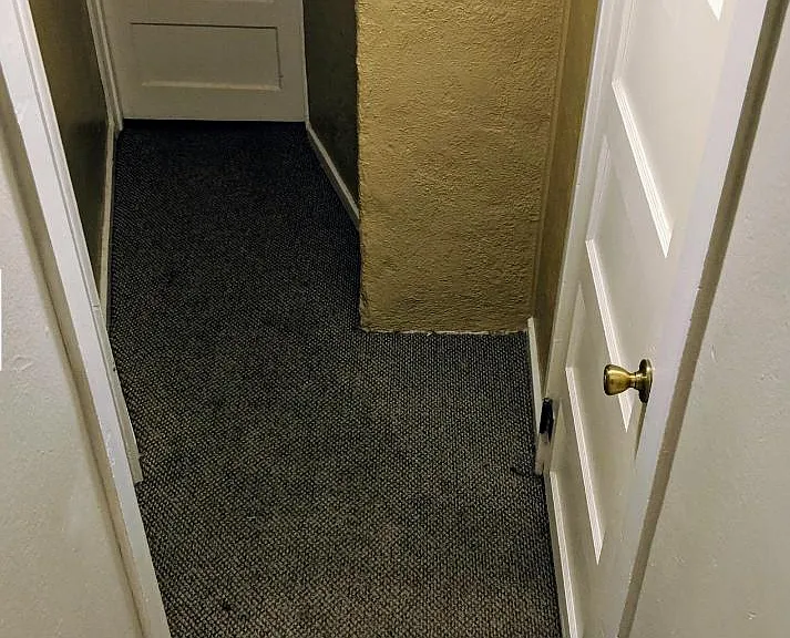 stairs to shared laundry (on left not visible) and downstairs one bedroom apartment