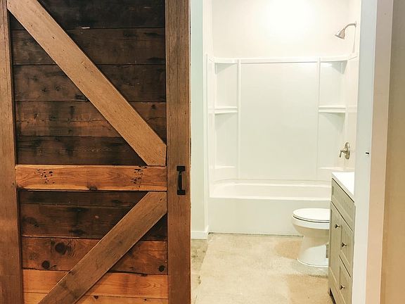 Beautiful, reclaimed, custom barndoor and large bathroom.
