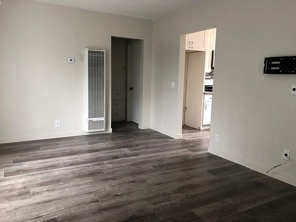 Living room view into kitchen, bathroom, and master bedroom. There is also walk in closet in hallway.