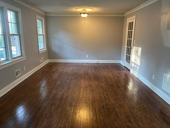 Living room looking into dining area. Check out those gleeming hardwood floors!
