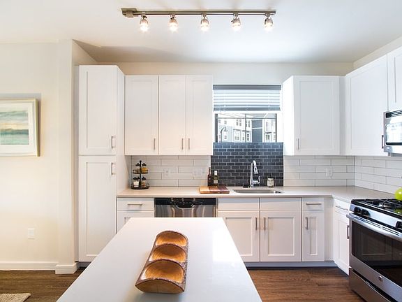 Quartz countertops, stainless steel appliances and custom cabinets in our contemporary kitchens