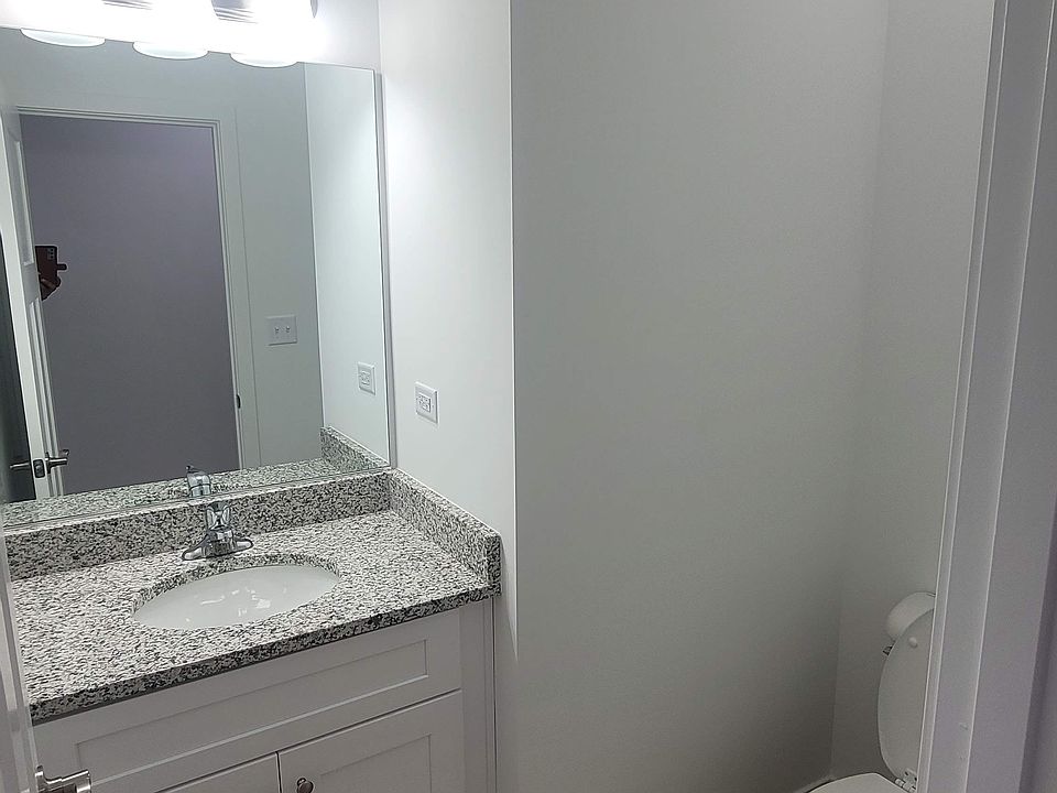Powder room with bright lights and upgraded vanities