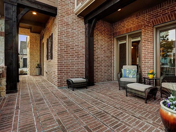 Front porch with room for outdoor seating. French doors leading into the sun room.