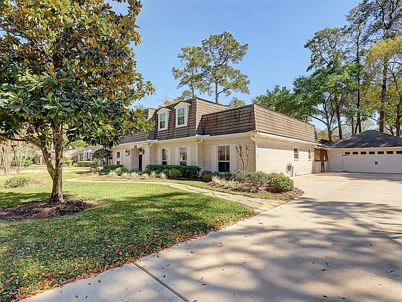Just wait until you see the garage, a real man cave. This angle illustrates the nice, wide concrete driveway, replaced in 2019, and the refaced garage. Plenty of space for off-street parking!