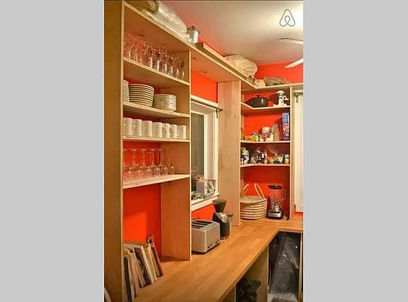 The pantry has tons of shelf and counter space for dishes food or whatever do you need to store. The door to the back deck is that the right of this picture.