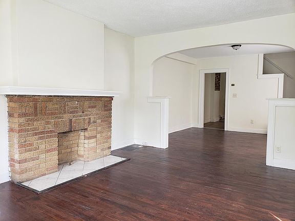 Living & dining room with hardwood floor & brick decommissio