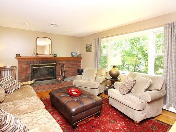 Living room has a fireplace, hardwood floors, recessed lighting and large picture window to let in lots of natural light.