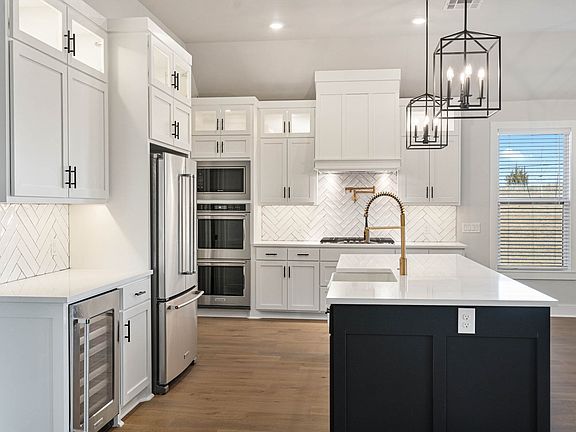 The kitchen has upgraded, stainless steel appliances.