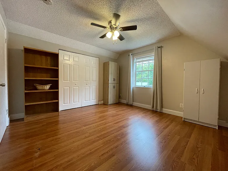 second upstairs bedroom with closet and storage. shuttered window