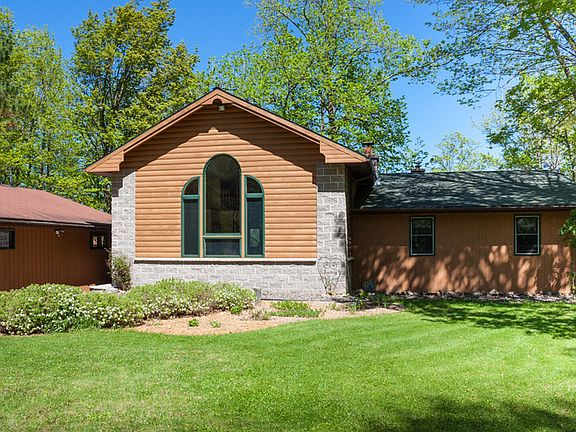 Quinn House - front yard : View of the house and garage as seen from the tree-lined driveway.