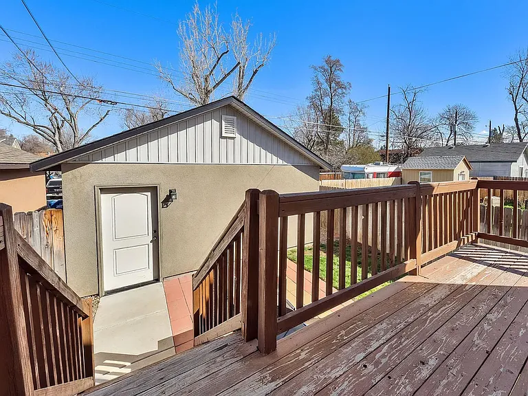 View of back yard from patio. Note the building behind the yard is the 2 car garage.