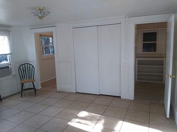 door to bonus room going toward kitchen, closet with slider, walk-in closet with shelves
