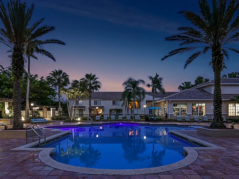 Pool at dusk with clubhouse views