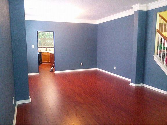 FORMAL DINING ROOM HAS ELEGANT CROWN MOLDING AND BEAUTIFUL RECENT FLOORING