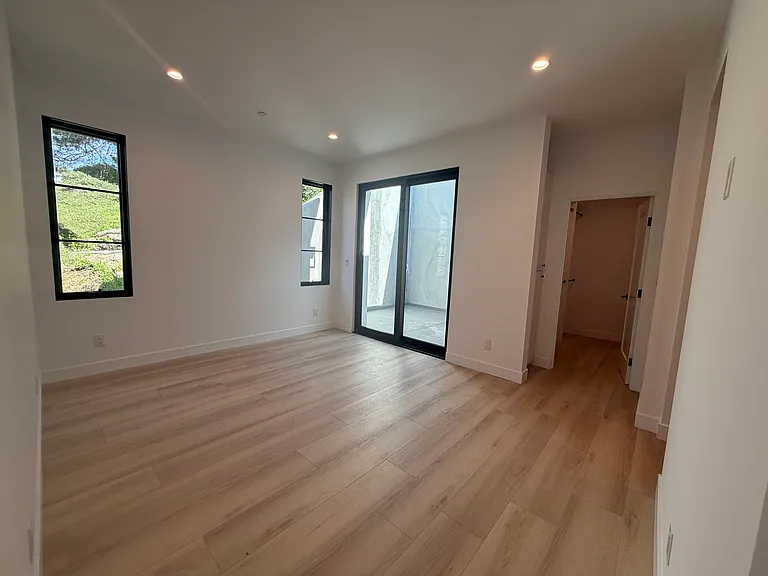 Large master bedroom with private patio and walk-in closet