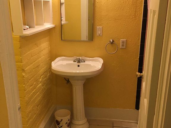 The bathroom is in the back.
