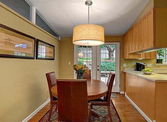 Dining room adjacent to the kitchen leads to a spacious rear dec