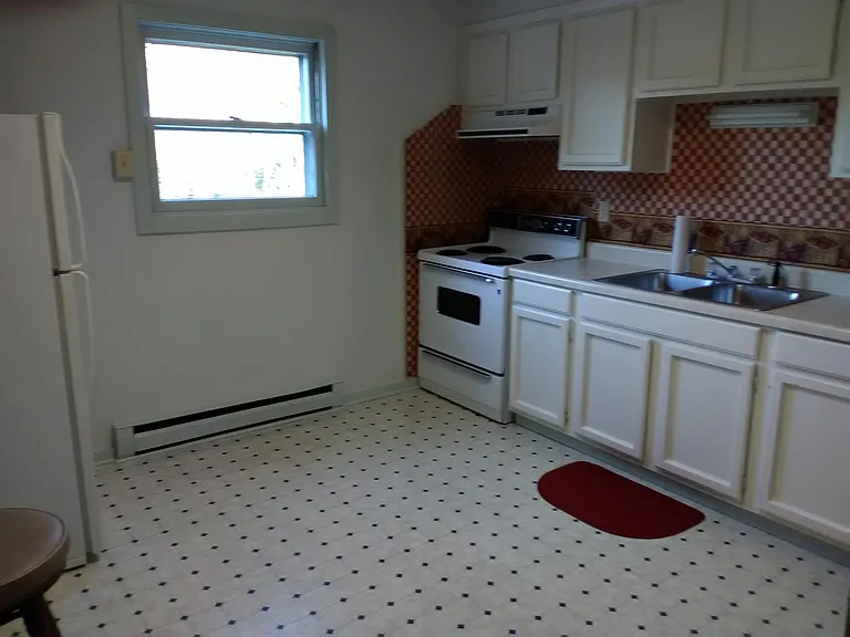 Large country kitchen with lots of cabinets and clean appliances, as shown.