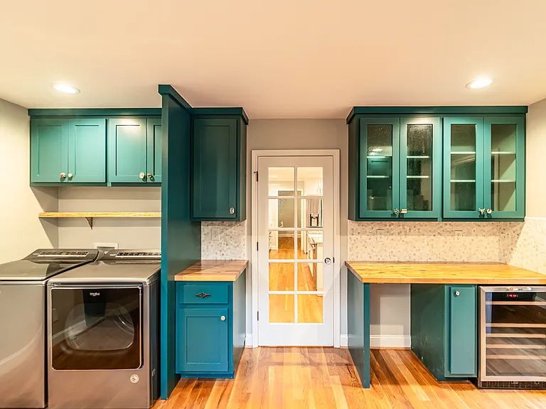Laundry facilities located in scullery. Washer and dryer included as a convenience or can be removed. Hookups for both electric and gas dryer.