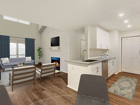 Renovated Package I kitchen, dining, and living areas with hard surface plank flooring