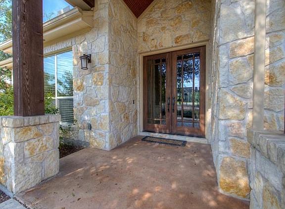 Beautiful stone work and front door entry of home.