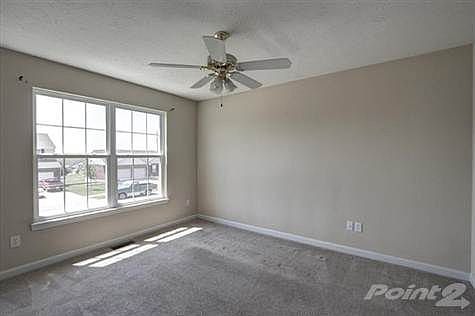 This open and spacious living/great room half wall capped off with wood trim, ceiling fan with lighting kit and plush carpeting throughout.