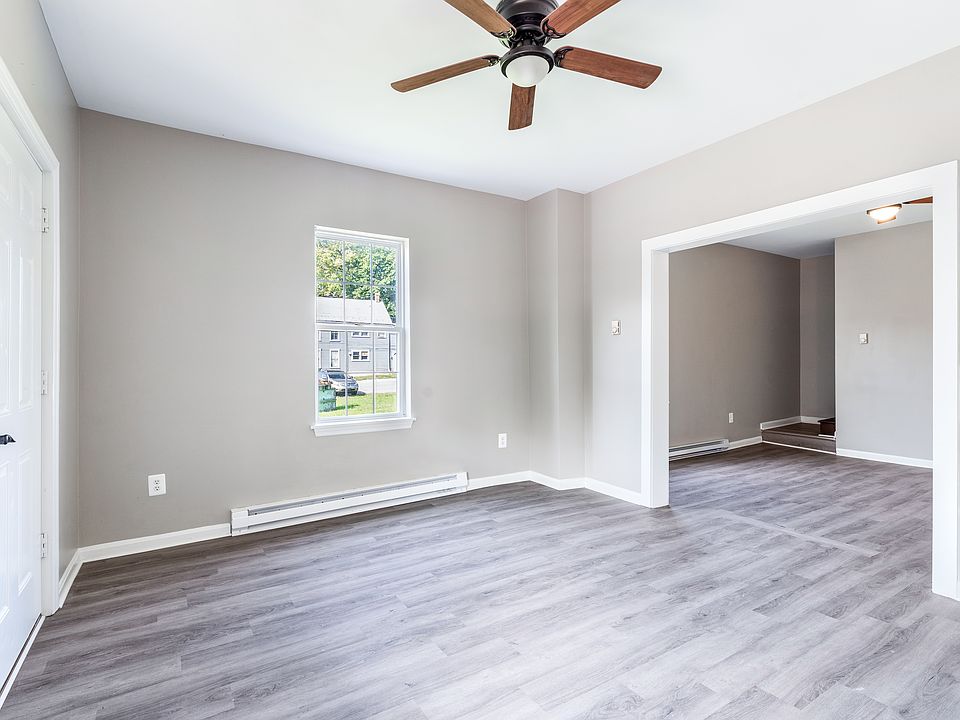 Living Room with door to the front of the house. Dinning room or additional living room, entry way to bottom of stairs